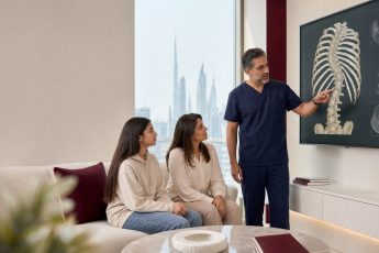 dr explaining about scoliosis surgery to mother and her child